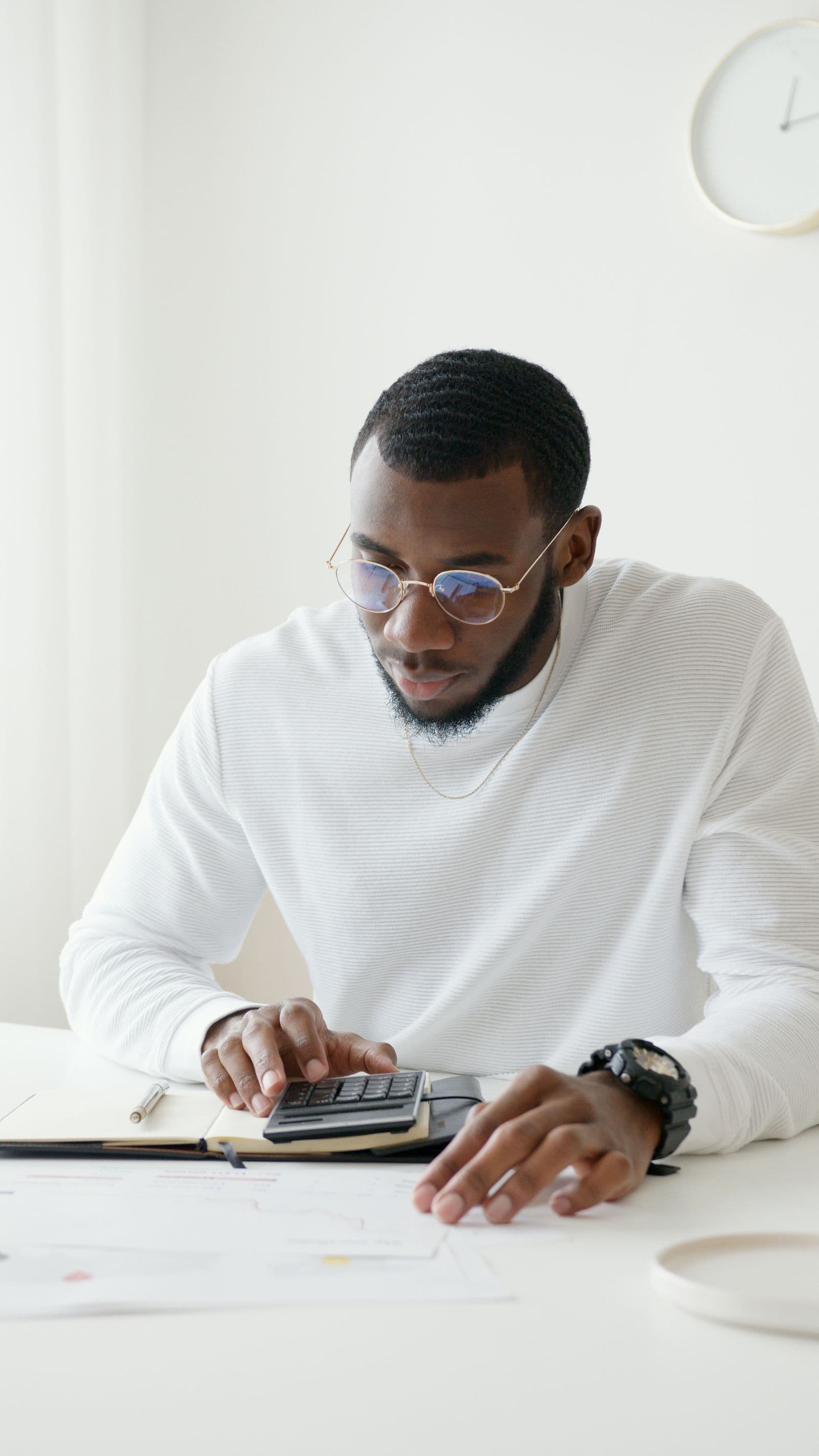 A person working figures out on a calculator