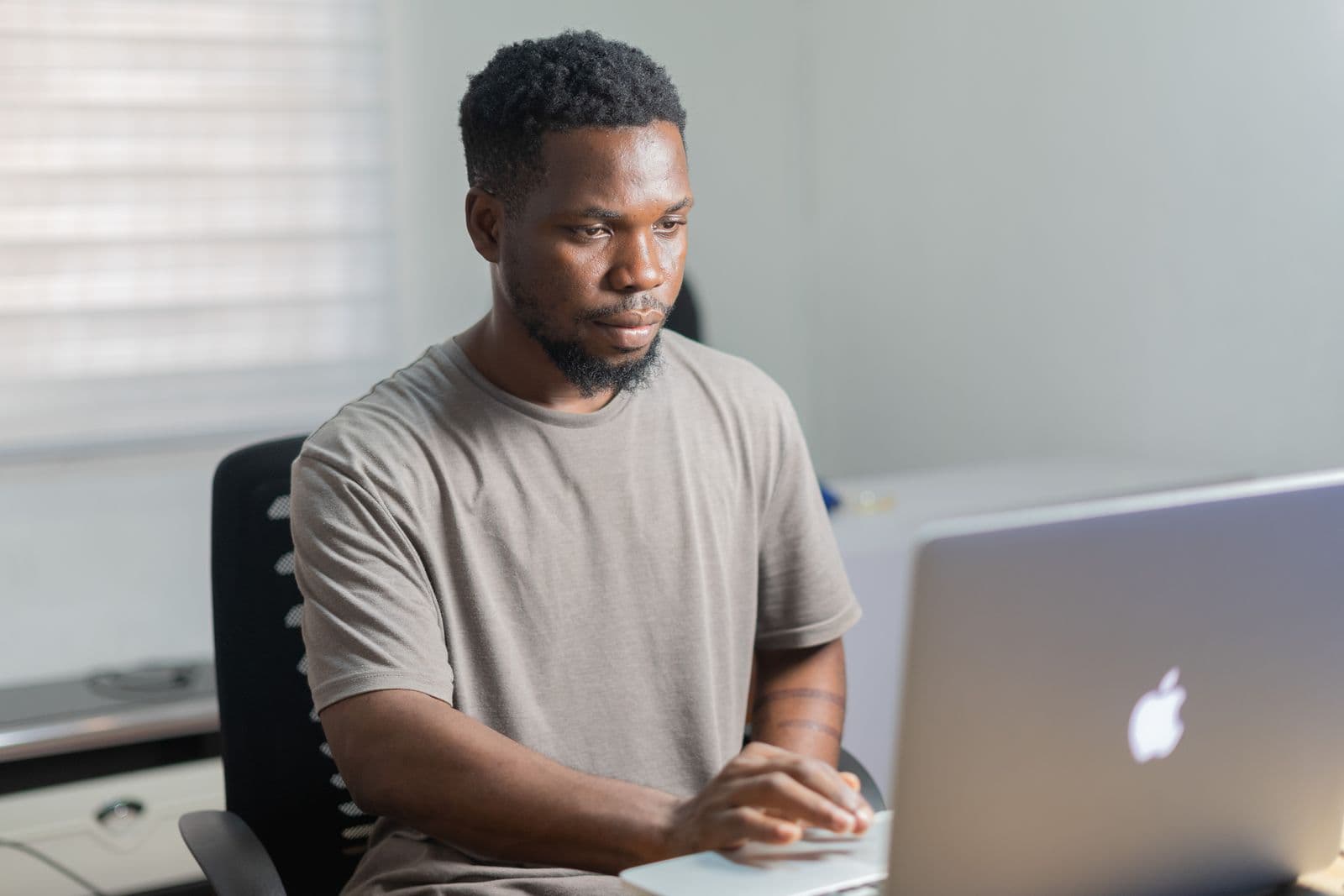 A man working through a spreadsheet on his laptop