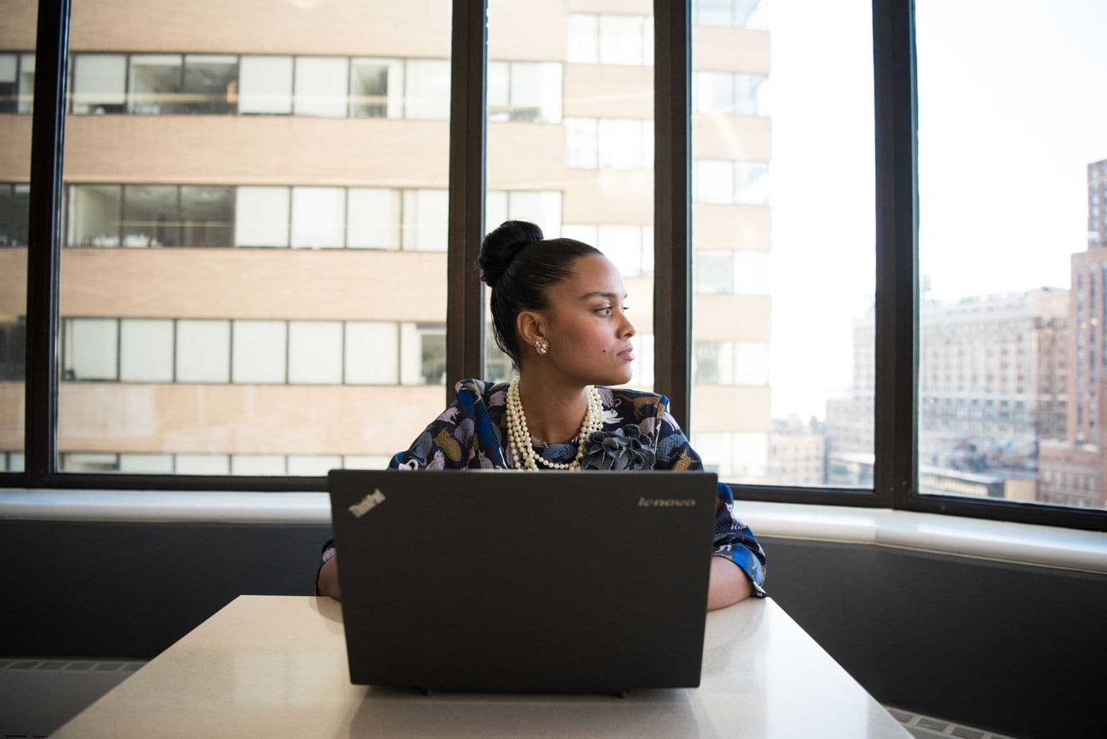 A woman reviewing documents at her desk